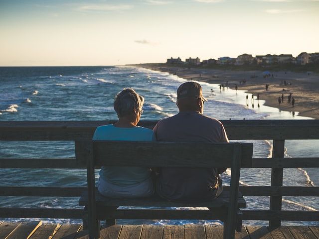 man and woman sitting on a bench