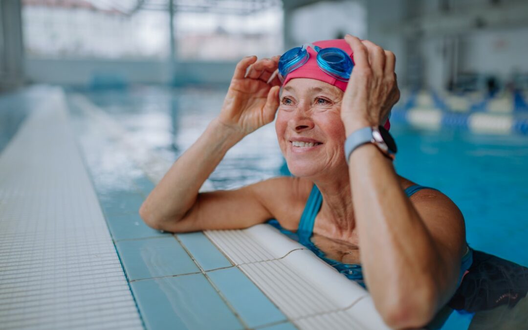 senior woman in a swimming pool leaning on the edge